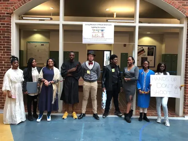 Image of a group of students dressed as African American figures from history that they selected to highlight as part of a day-long community event designed to engage participants in the themes of The 1619 Project. 