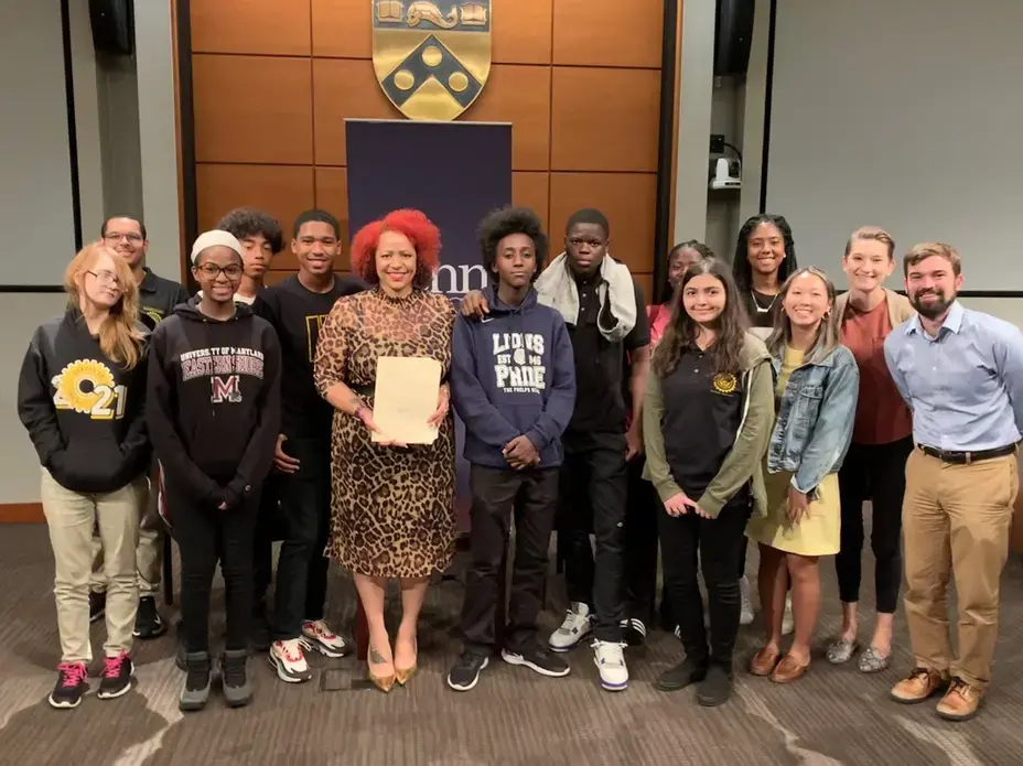 Image of students from George Washington Carver High School in Philadelphia, PA pose with Nikole Hannah-Jones from The New York Times Magazine