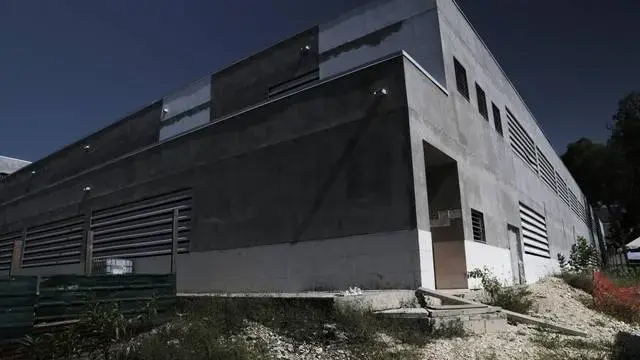 Exterior of the yet to open new General Hospital. The sprawling new hospital campus was one of the first projects approved for Haiti’s reconstruction following the earthquake of Jan. 12, 2010. A decade later, the 534-bed teaching hospital has yet to open its doors to a single patient. Image by Jose A. Iglesias. Haiti, 2019.