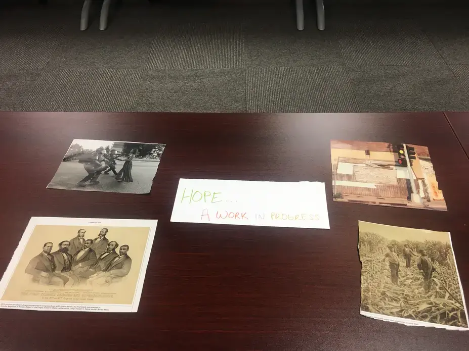 Participants in a professional development workshop in Houston, Texas, curate and title photography exhibitions using images from The 1619 Project.
