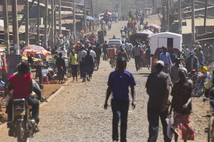 People move about the main thoroughfare in the Kawangware slum. Image by Mark Hoffman. Kenya, 2017. 