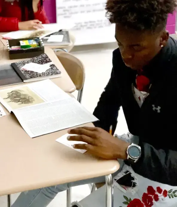 Image of a student creating a reading guide for The 1619 Project