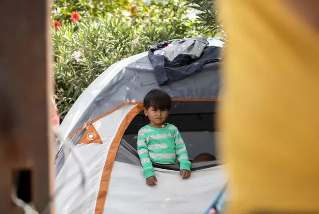 The camp near the Gateway International Bridge, which connects Matamoros and Brownsville, began forming last year. Media reports say Mexican officials plan to move the migrants to a stadium farther from the river. Image by Miguel Gutierrez Jr. Mexico, 2019.