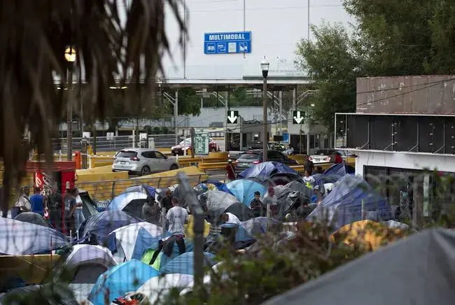 The camp near the Gateway International Bridge, which connects Matamoros and Brownsville, began forming last year. Media reports say Mexican officials plan to move the migrants to a stadium farther from the river. Image by Miguel Gutierrez Jr. Mexico, 2019.