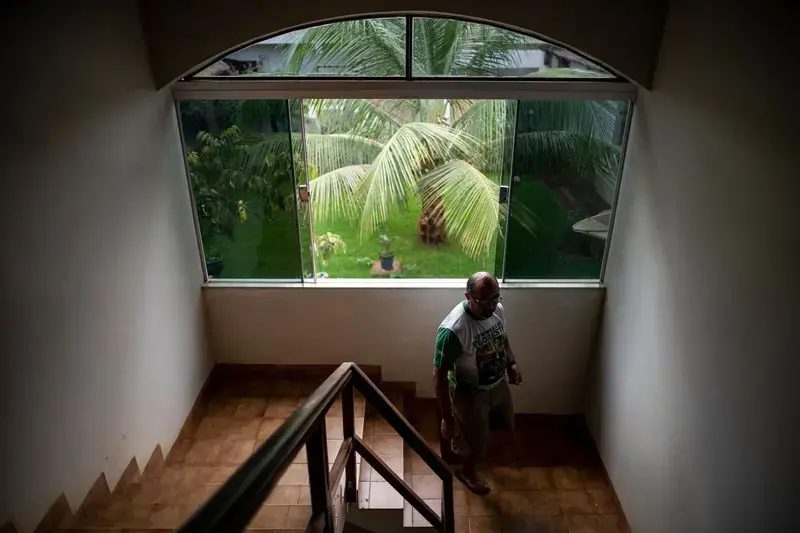 Father Amaro Lopes walks through the bishop’s house in Altamira. Image by Spenser Heaps. Brazil, 2019.