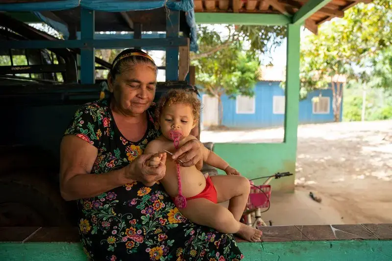 Maria de Lourdes da Fonseca Lima trims the fingernails of her granddaughter, Riquelme da Silva Lima, 3, at their home in the Virola Jatoba settlement in Anapu. Image by Spenser Heaps. Brazil, 2019.