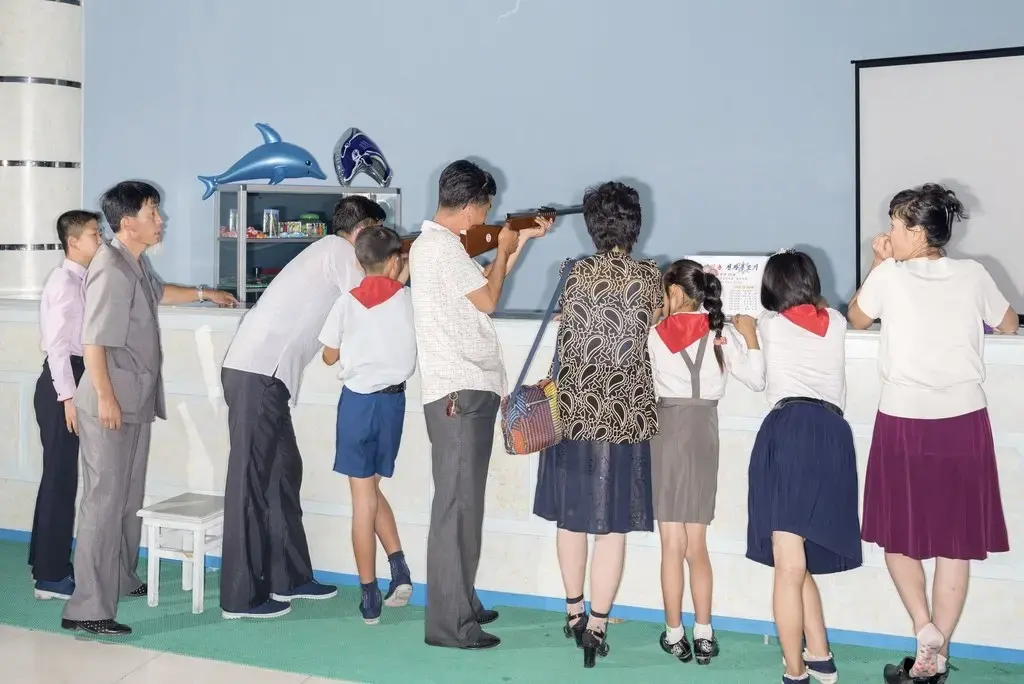Families enjoy National Liberation Day (August 15th) at the Rungna Dolphinarium. Image by Max Pinckers/The New Yorker. North Korea, 2017.