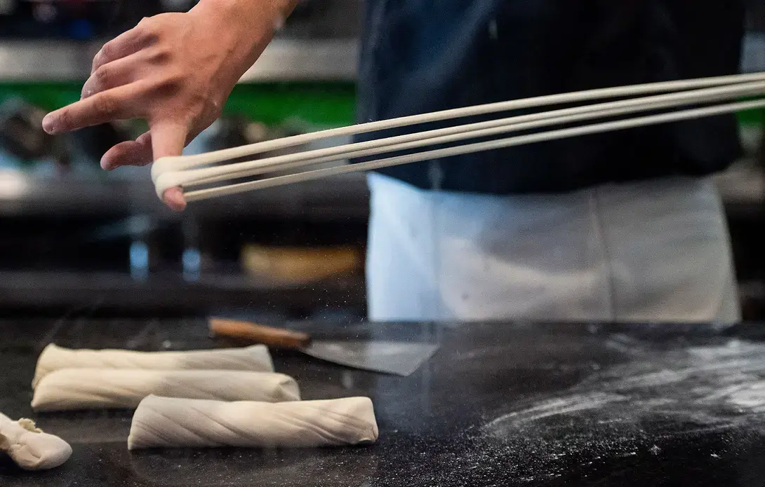 Tony Mao makes noodles at Everyday Noodles in Squirrel Hill. Image by Stephanie Chambers. United States, 2018.