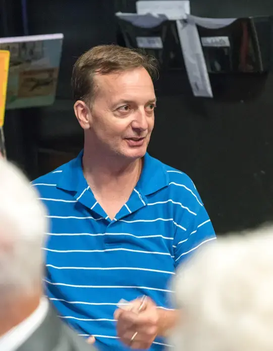 Craig Richardson, an associate professor of economics at Winston-Salem State University and consultant for HanesBrands, describes his experience teaching the student filmmakers about the history of innovation in Winston-Salem as a part of their research for Weaving Connections. Image by Robert Merritt. United States, 2017.