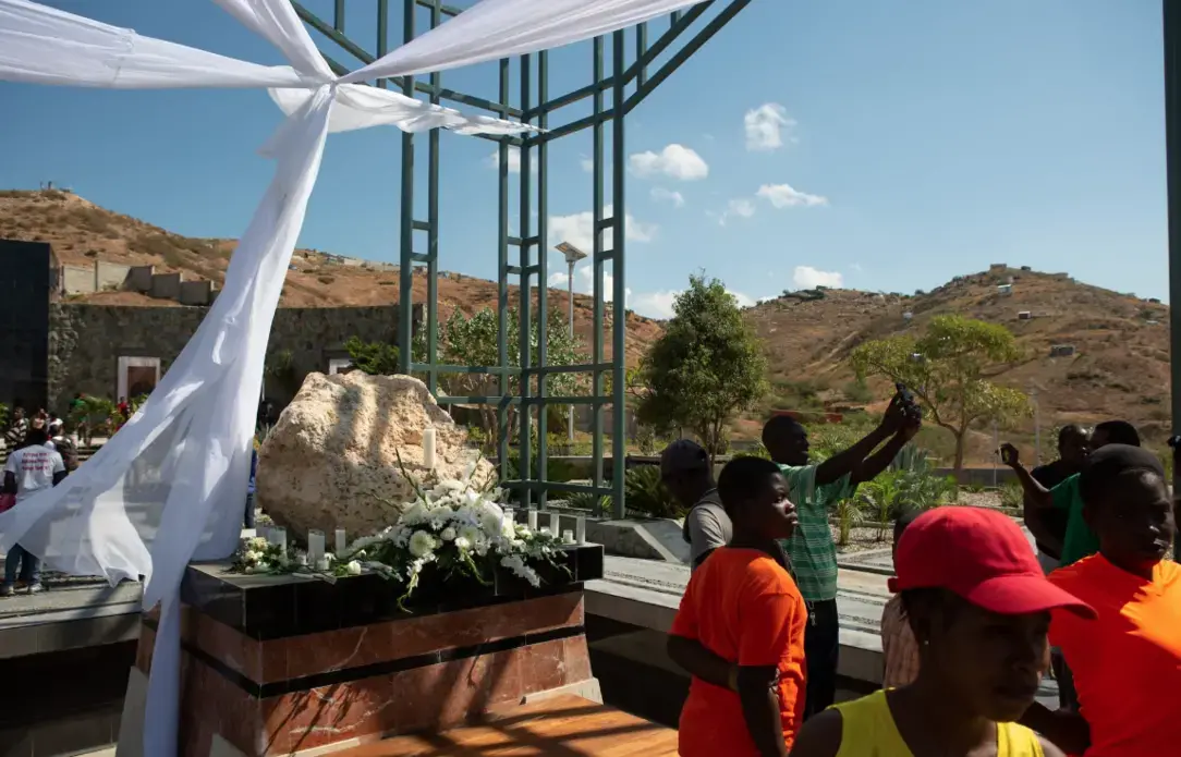 Local residents investigate the St. Christophe memorial after the official wreath-laying ceremony, which was private. Image by Allison Shelley. Haiti, 2019.