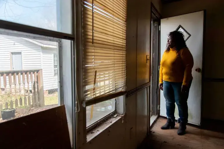 Sellers, South Carolina, Mayor Barbara Hopkins shows homes damaged by repeated flooding and hurricanes on February 13, 2020. While many homeowners across the small town have received help from FEMA and other natural disaster response agencies, those without a clear title for their home have been left with no government help in mold saturated homes. Image by Joshua Boucher. United States, 2020.<br />

