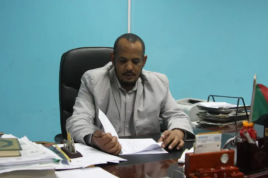 Mohammed Elhag Hamed, a physician at Omdurman Teaching Hospital, looks over some of the files documenting corruption under the former regime in Omdurman, Sudan, on Nov. 3. Image by Rebecca Hamilton/ Foreign Policy. Sudan, 2019.