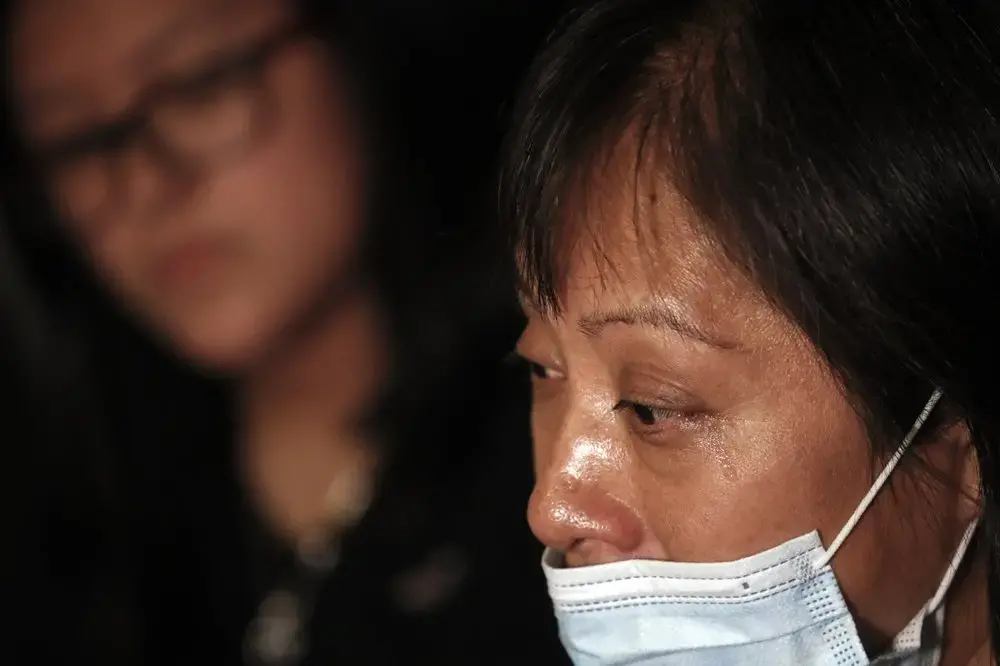 Magnolia Ortega cries during an interview at home in Staten Island, New York, Wednesday, June 24, 2020, as she explains her bout with cancer and the fear of never seeing her daughters again. Ortega, whose cancer is in remission, says she's considering returning to her hometown of San Jeronimo Xayacatlan, Mexico but says there's no work there and that would mean one less family member sending back one less monthly check. “If I go back,” she said, “we won’t have anything.’’ Image by John Minchillo/AP Photo. United States, 2020.