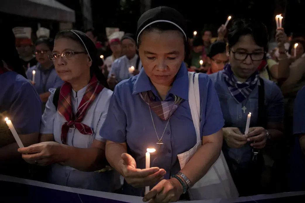 Nuns light their candles during a demonstration calling for "truth, justice, and peace" across Malate Church in Manila. Image by Eloisa Lopez. Philippines, 2019.