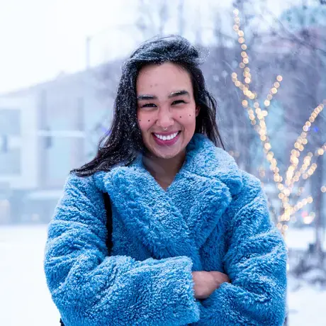 Alice Qannik Glenn pictured in a blue furry coat in the snow