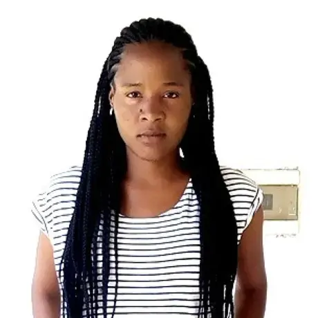 A woman with black hair and a striped black and white shirt.