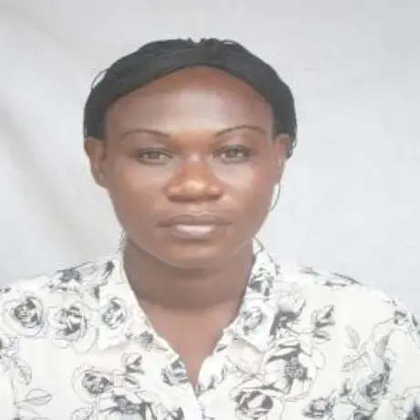 A woman wears a white floral-patterned shirt.