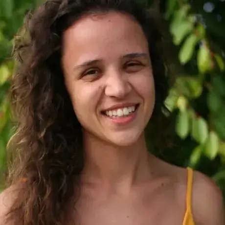 A WOMAN SMILES INTO THE CAMERA