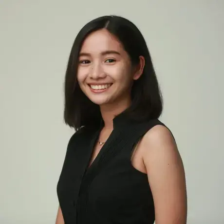 Headshot of a woman with medium length dark hair wearing a black dress