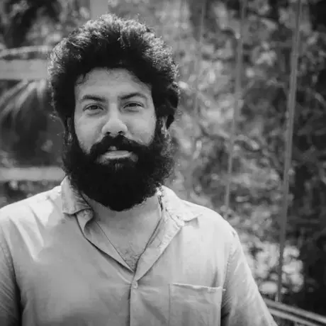 Black and white photo of a man with a beard and curly hair