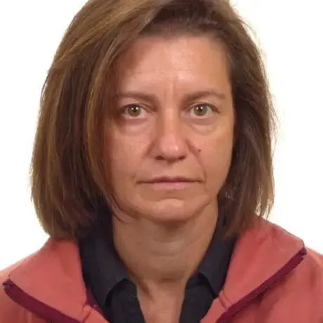 Woman with medium length brown hear wearing a red jacket