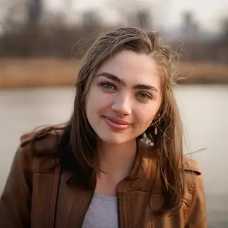 Woman with long brown hair smiles at the camera