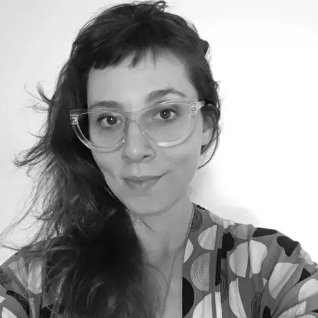 Photo of a woman with long dark hair and glasses