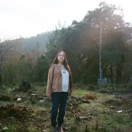 Judith Serber stands on the edge of a wooded area for a portrait