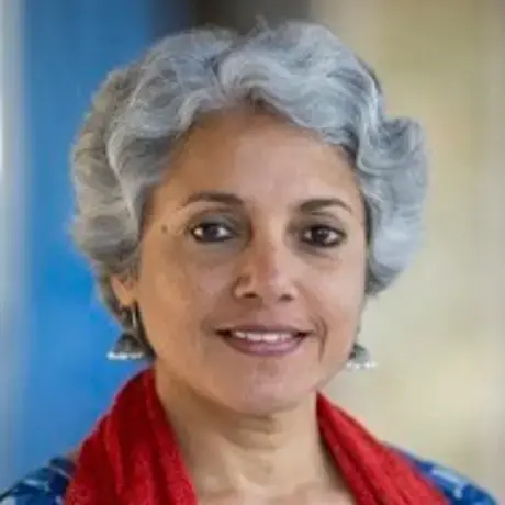 Headshot of a woman with short grey hair wearing a red scarf