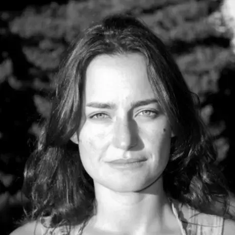 Black and white headshot of a woman with long dark hair
