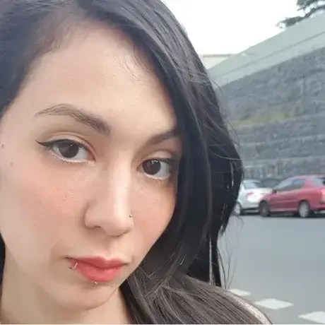 Image of a woman with long dark hair on a city street
