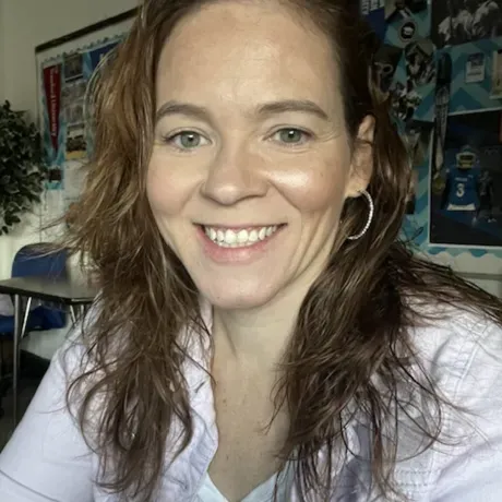 A woman wearing a white shirt poses for a profile photo