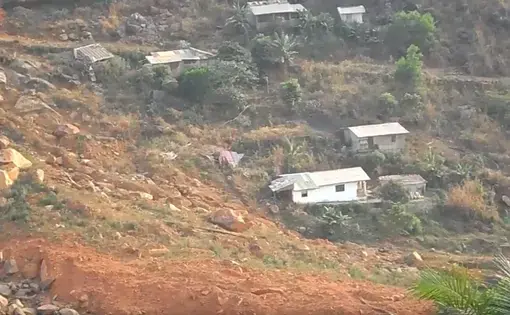 The scarred site of Sugar Loaf  Mountain that came tumbling down August 2017 claiming the lives of more than 1,000 Sierra Leoneans. Image by Kadia Goba. Sierra Leone, 2018.