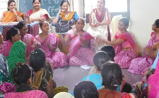 Health workers circle up to perform folklore songs during a Breastfeeding Clinic event run by Manav Sadhna. Image by Ambar Castillo. India, 2017.