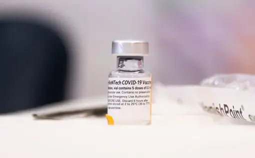A vial of the Pfizer-BioNTech COVID-19 vaccine. Image by noamgalai / Shutterstock. United States, 2020.