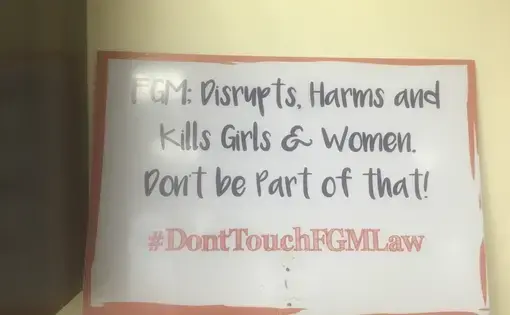 A sign found at Equality Now in Nairobi, a non-governmental international women's rights organization, describes the effects of FGM and urges people to fight against it. Image by Merdie Nzanga. Kenya, 2018.