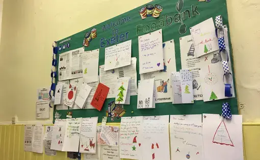 A recent talk by members of the Food Bank inspired Girl Guides to donate. The noticeboard is now covered with posters for support agencies and letters from the Girl Guides. Image by Caitlin Bawn. England, 2016.