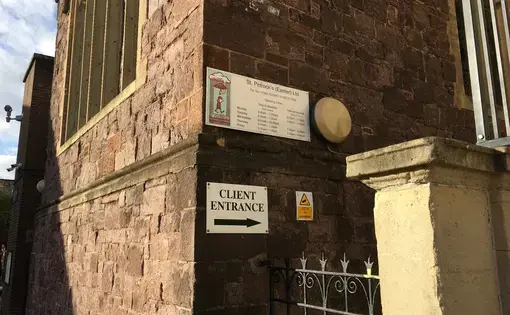 The client entrance to St Petrock's, unobtrusively tucked down the side of a methodist church by the same name. Image by Caitlin Bawn. England, 2016.