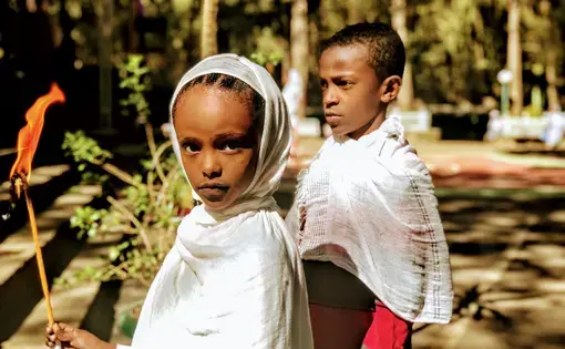 A young Orthodox Christian girl outside of St. Mary Entoto in Addis Ababa, Ethiopia. Image by Arianne Lachapelle Henry. Ethiopia, 2019.