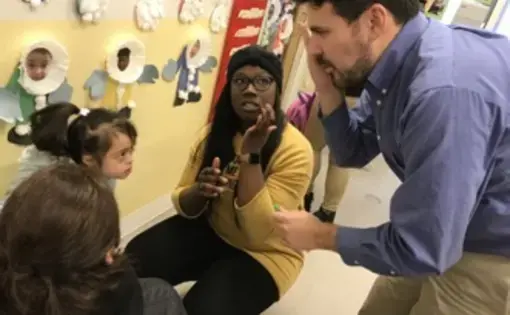 Egan was negotiating between a parent and a teacher. The girl accidently scratched herself during the day, and Egan was asking the girl questions in Spanish. Image by&nbsp;Thea Gu. United States, 2017.