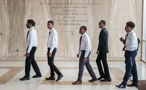 Freshmen enter the Morehouse chapel named for Martin Luther King, Jr., whose words are etched on the wall. The weekly, required Crown Forum assembly introduces leaders who address issues of the day. The all-male college aims to develop disciplined men who will lead lives of scholarship and service. Image by Radcliffe "Ruddy" Roye. United States, 2017.