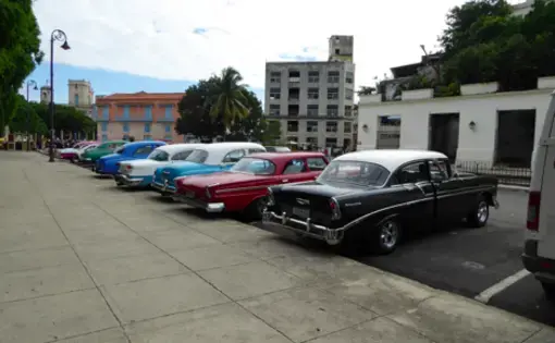 Old cars still adorn the streets in Havana, providing an ever-present reminder that the U.S. enforced embargo still restricts this island nation. While the embargo has caused building projects to be delayed and car importation to be largely blocked, media is still finding its way in through El Paquete and other black market means. Image by William Neely. Cuba, 2016.