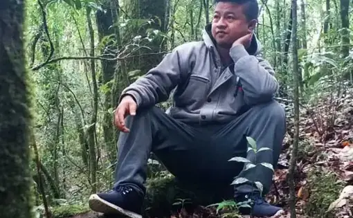 Borhlang Blah, 27, inside a sacred grove—a community forest protected by his village—in Mawphlang, Meghalaya. When Blah was growing up, the grove was denser and walking difficult. The grove and Meghalaya’s forests have thinned out since. Image by Disha Shetty. India, 2019.