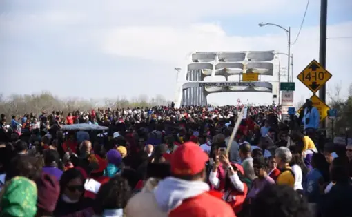 Marchers commemorating the ‘Bloody Sunday’ events of 1965 approach the Edmund Pettus Bridge, in Selma, Alabama, this past Sunday. Image by Brittany Gibson. United States, 2020.