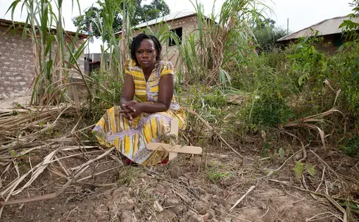 Phyllis Omido stands next to a child's grave in Owino Uhuru, a village plagued with lead exposure due to an unregulated smelter in operation from 2007-2014. Image by Goldman Environmental Prize, 2015.