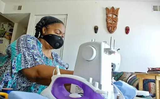 Kim Daniel makes her own masks for her protection at her home in Preservation Square. Image by Wiley Price / St. Louis American.&nbsp;United States, 2020.