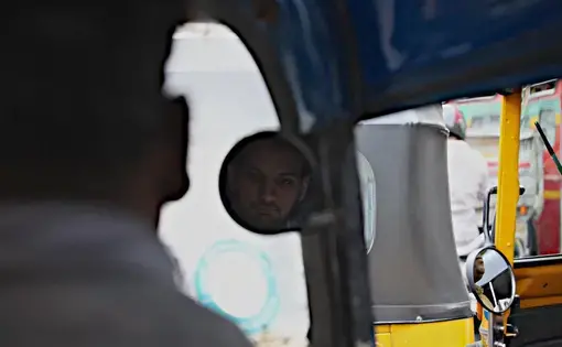Priyank Mathur, creator of the "Fight Terror With Comedy" programs rides in a rickshaw through Mumbai. Image by Wes Bruer. India, 2017.