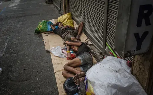 Many families sleep on Mabini Street of Malate, Manila, often suffering not only from poverty but substance abuse problems. By May 2016, a little over one month before the inauguration of Philippine President Rodrigo Duterte, extrajudicial killings have taken the lives of over 8,000 Filipinos. As of June 2017, almost all the homeless who sleep on Mabini Street are no longer there, their whereabouts unknown. Image by James Whitlow Delano. Philippines, 2016.