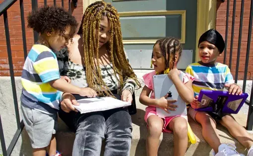 Courtnesha Rogers with her children, (from left) Angelino, 2, Angele and Angelo, both 4. Rogers is eager for them to start school again, but wonders about the measures that will be taken to keep them safe. Image by Wiley Price/St. Louis American. United States, 2020.