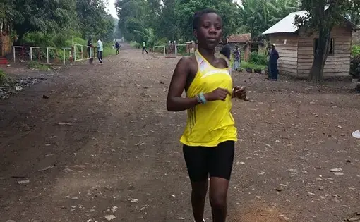 Beatrice Kamuchanga runs down the main road in Kirotshe, Democratic Republic of Congo.